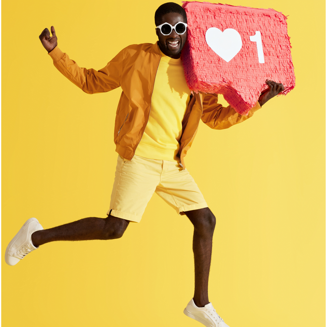 Man wearing glasses, wearing yellow holding a social media icon